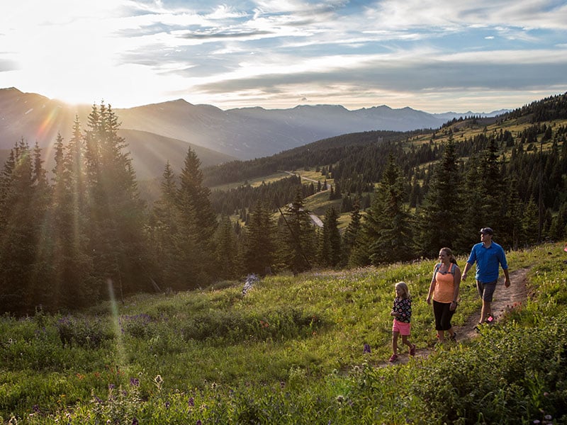 family hiking at sunset at black powder pass