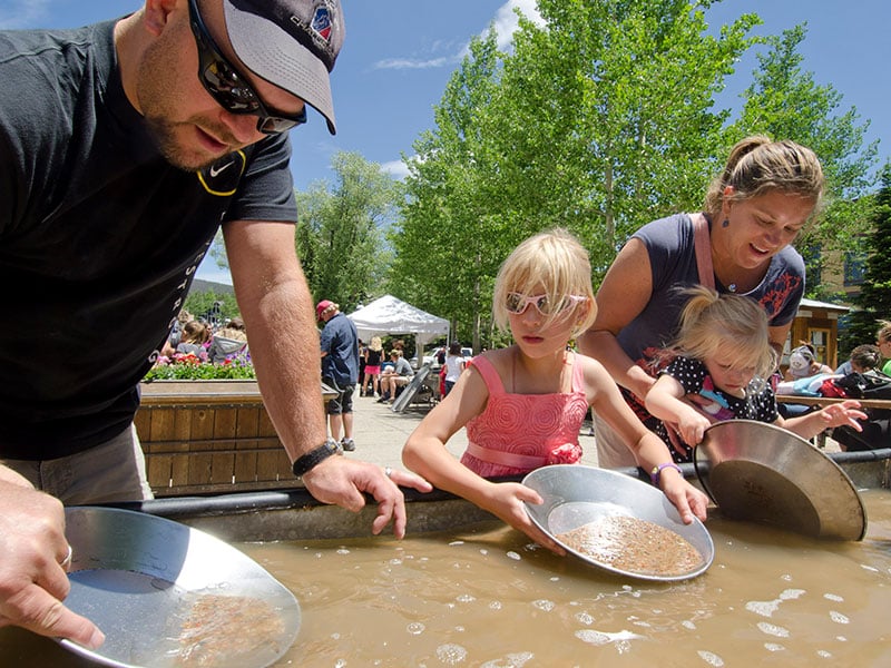 family gold panning during a summer day
