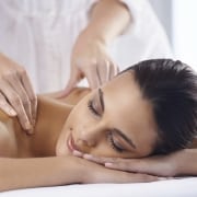 A young woman receiving a massage from a massage professional