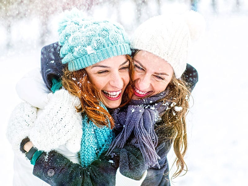 Friends hugging in the snow